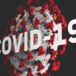 Digital rendering of the Coronavirus with "COVID-19" written across it. Stock photo by Martin Sanchez via Unsplash