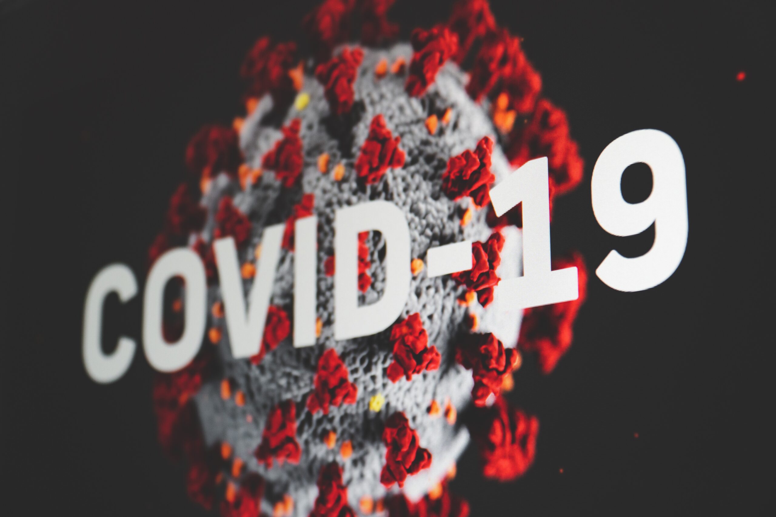 Digital rendering of the Coronavirus with "COVID-19" written across it. Stock photo by Martin Sanchez via Unsplash